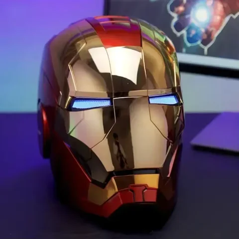 Gold Iron Man MK5 helmet with blue LED eyes lit, front view on a desk