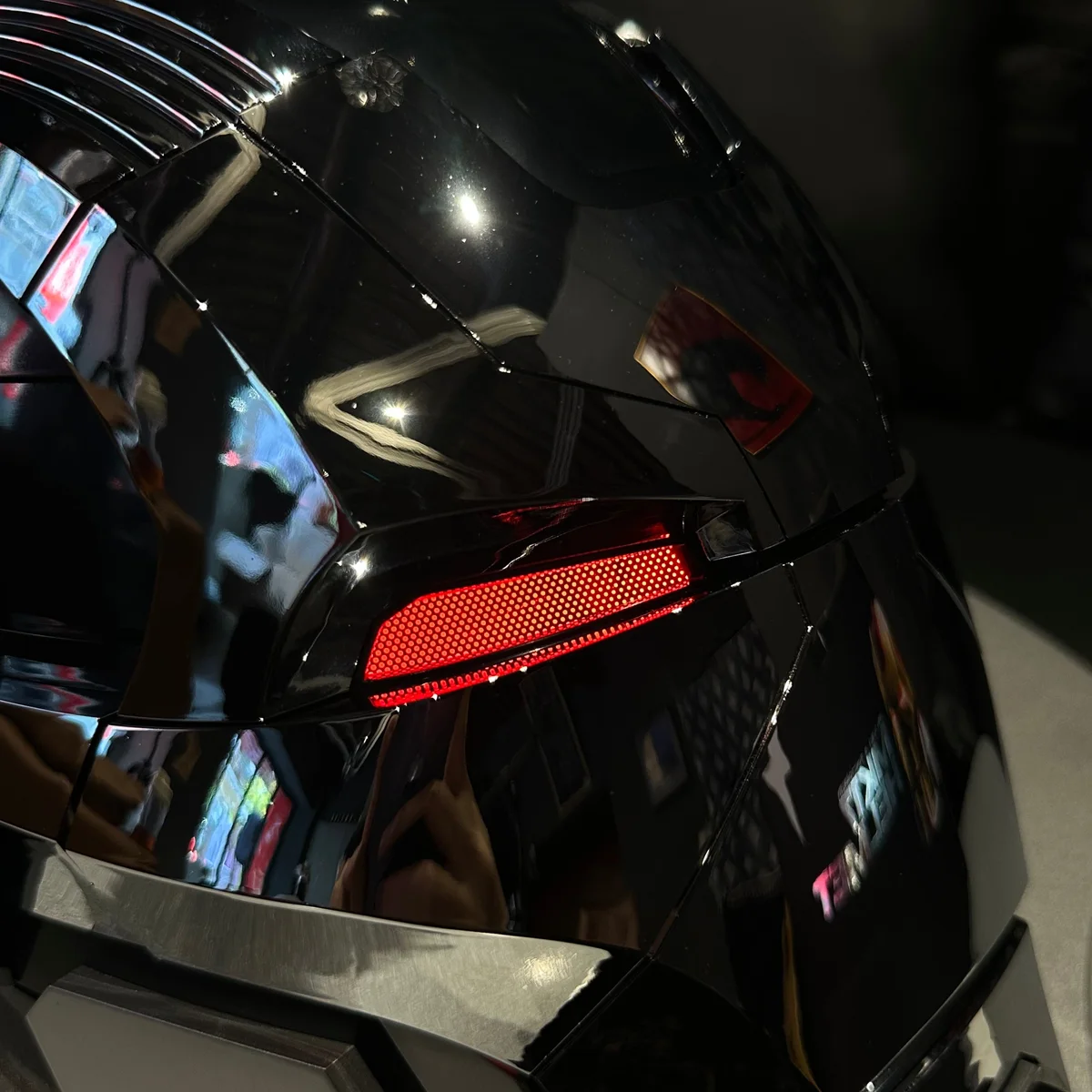 Close-up of the red LED eye on the gloss black Iron Man MK17 helmet